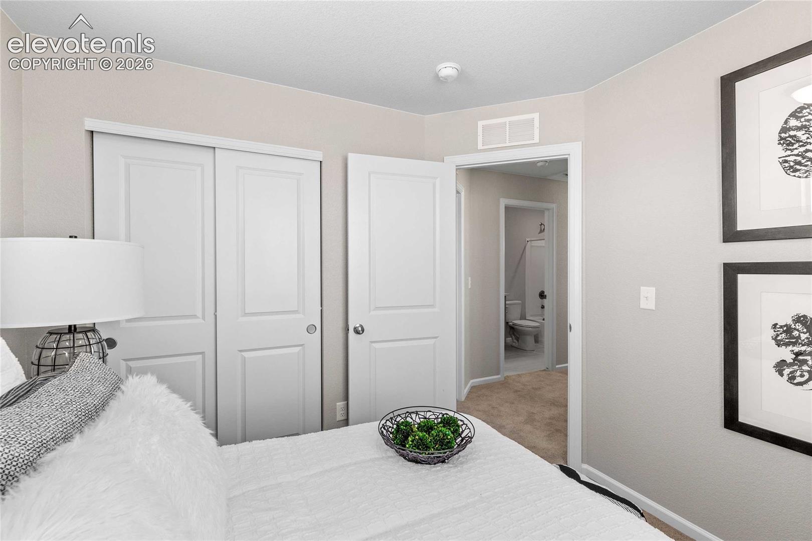 Recessed lighting, light-colored wall paint, white trim, paneled doors, and carpeted flooring
*photos of a model home*