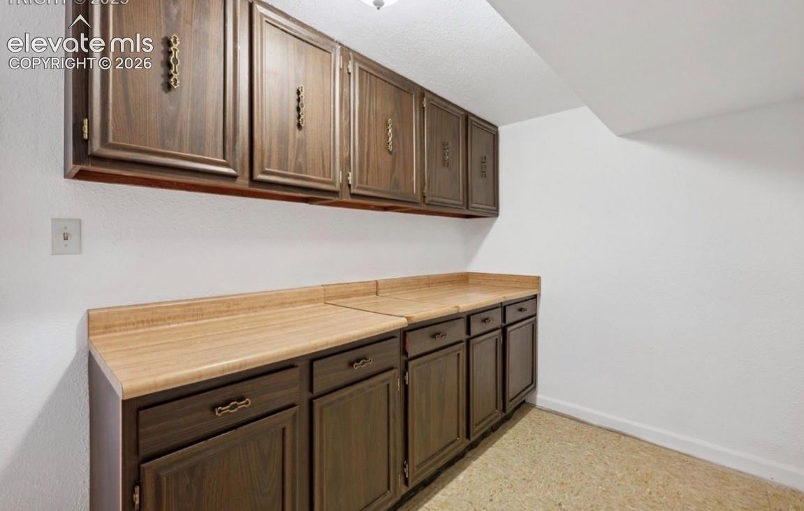 Extra room with cabinets and storage in basement