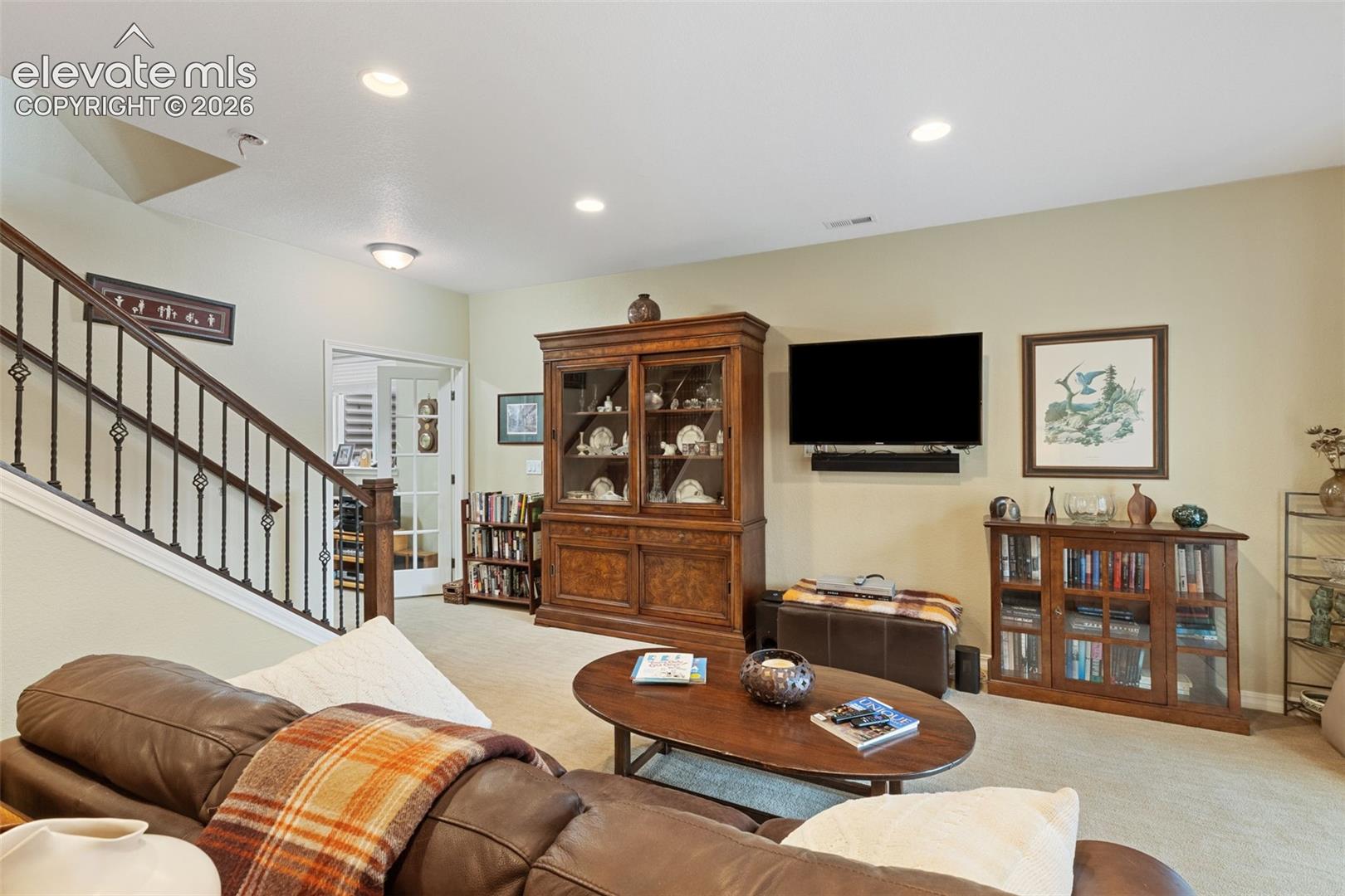 Open living area featuring recessed lighting and wall-to-wall carpeting.