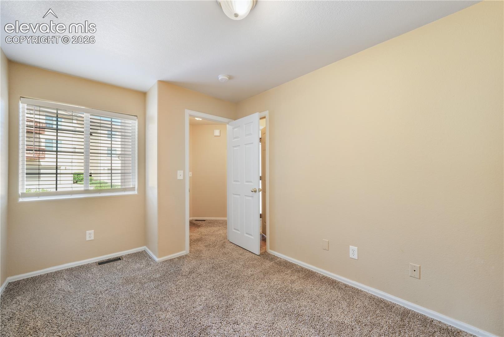 First bedroom, main floor at front of home with connecting access to the 3/4 bathroom