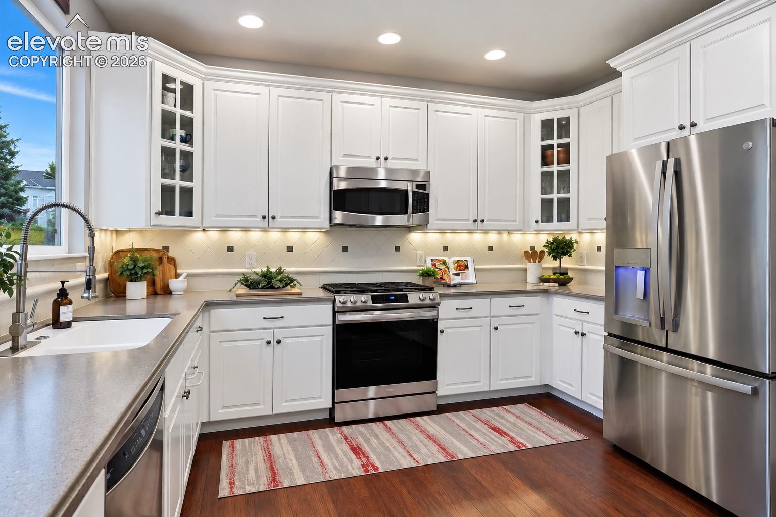 Abundant cabinetry, expansive counters and stainless appliances combine style with practical storage.