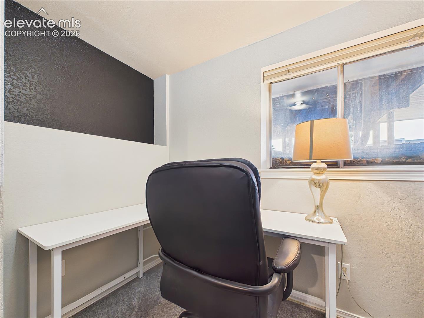 Dedicated office nook with built-in desk space and a window for natural light, creating a practical workspace for remote work or study.