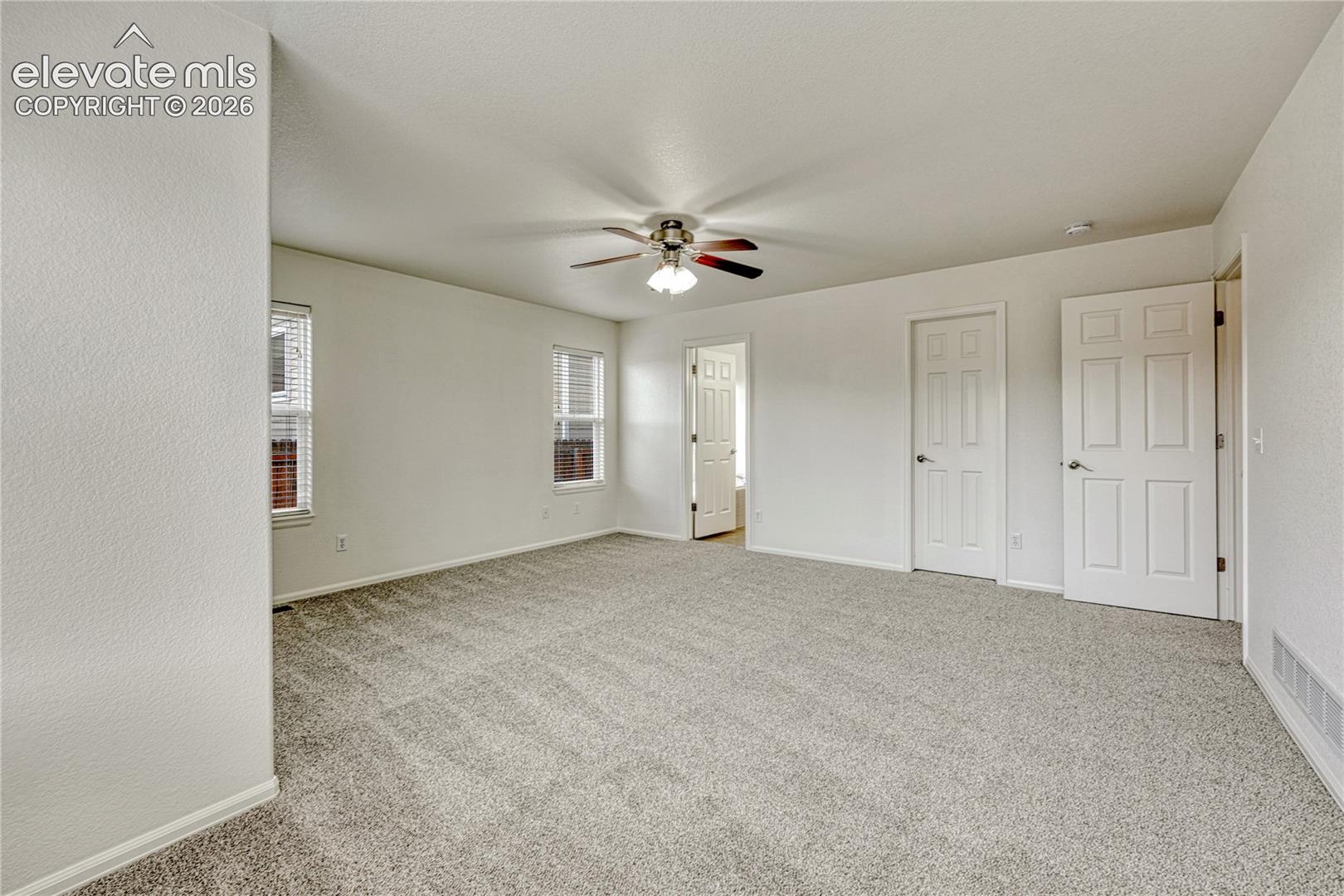 Primary bedroom has walk-in closet and new carpet and paint.