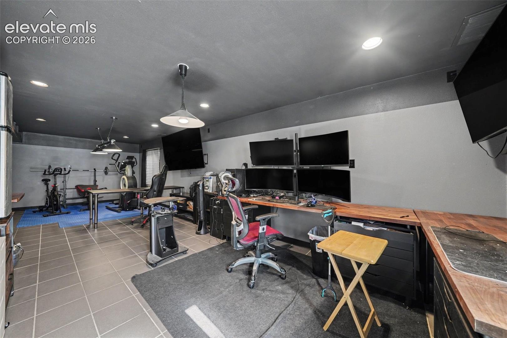 Tile flooring, recessed lighting, and custom built-in wood-surface desk cabinetry
