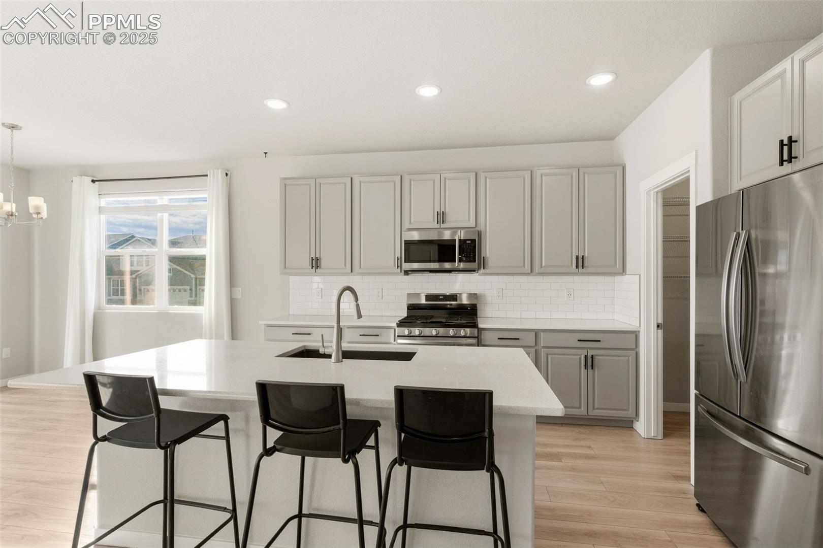 With Beautiful quartz counter tops and big island.   