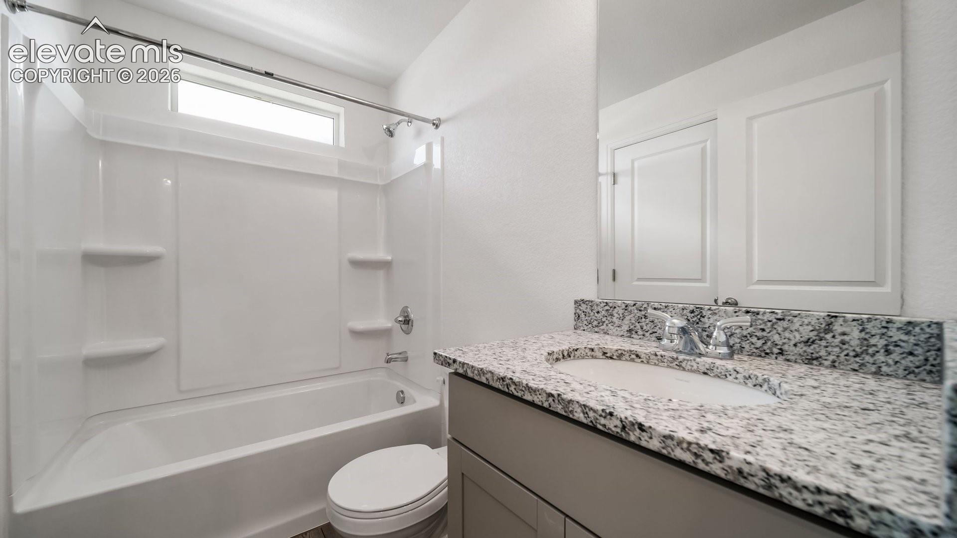 Tub/shower combination with a transom window, chrome fixtures, and built-in shelving
*photos of a model home*