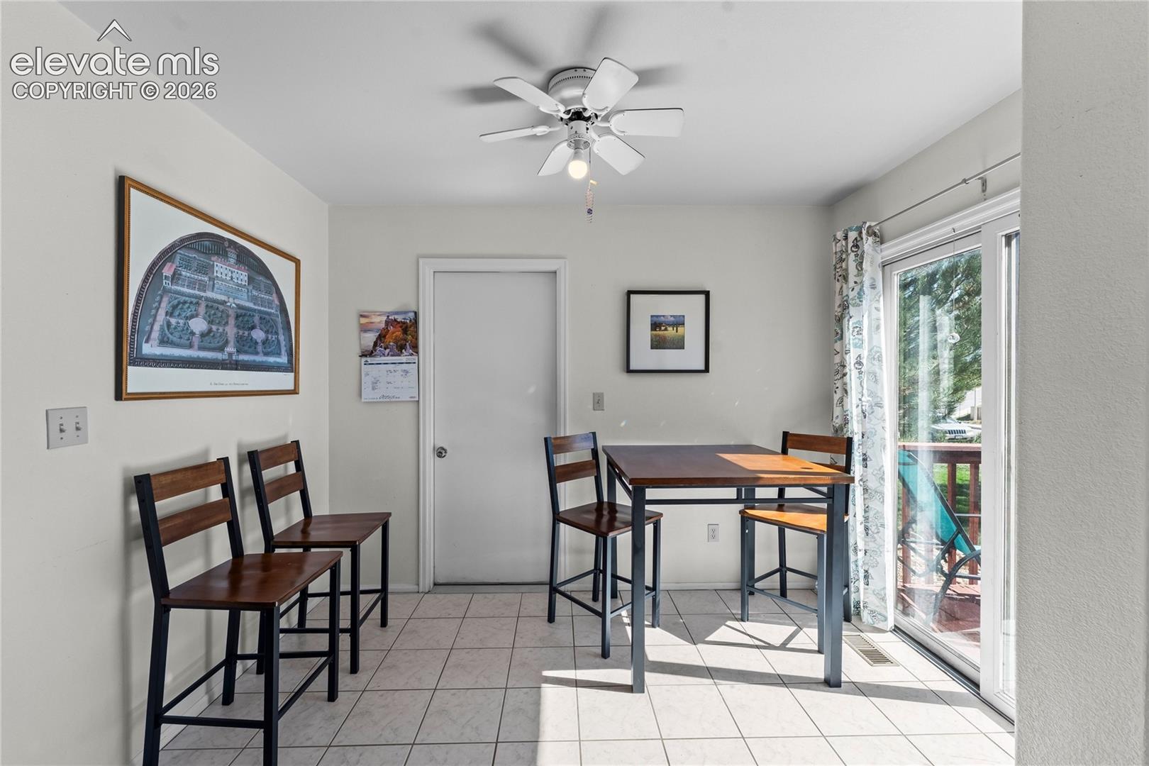Ceramic tile flooring, ceiling fan with integrated lighting, and white interior door