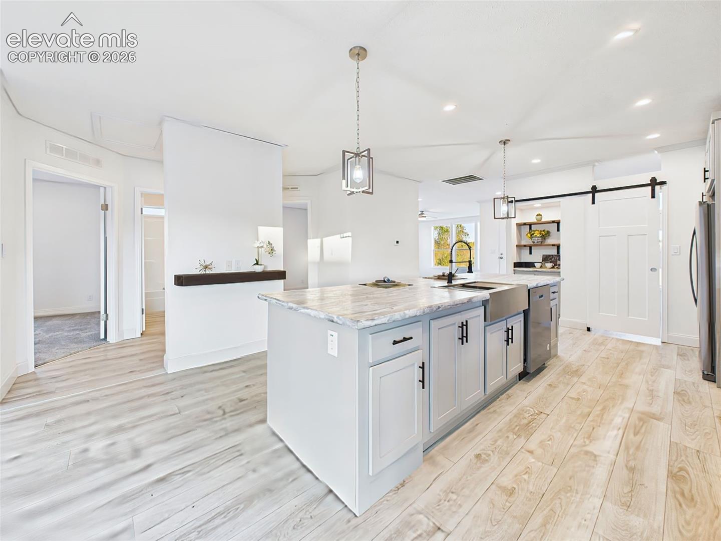 View from the island showcasing open flow into the Bedroom hall and abundant natural light.