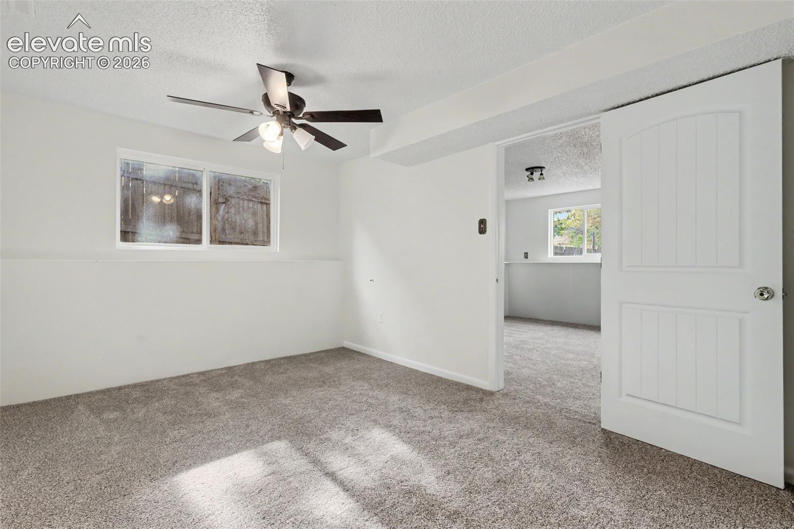 Lower level primary bedroom with attached ¾ bathroom and new carpet.