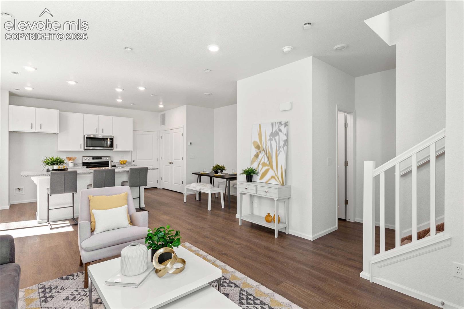 Contemporary kitchen featuring white cabinetry, stainless steel appliances, and a breakfast bar
*photos  of a model home*