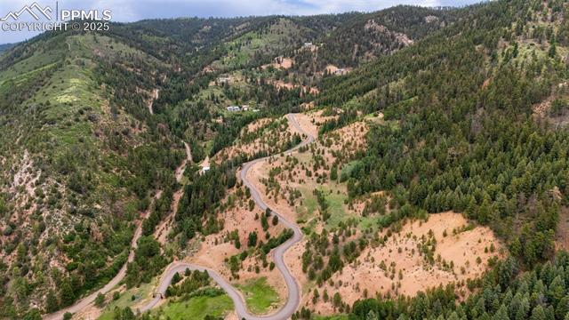 Drone / aerial view of mountains and a heavily wooded area