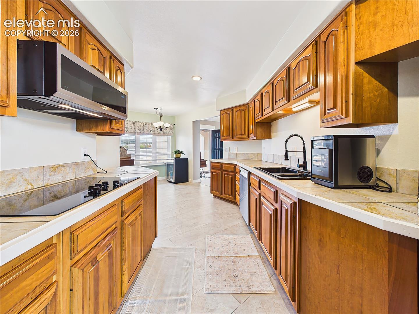 Bright and functional kitchen features abundant storage, expansive countertops, and a seamless connection to the adjacent dining area.