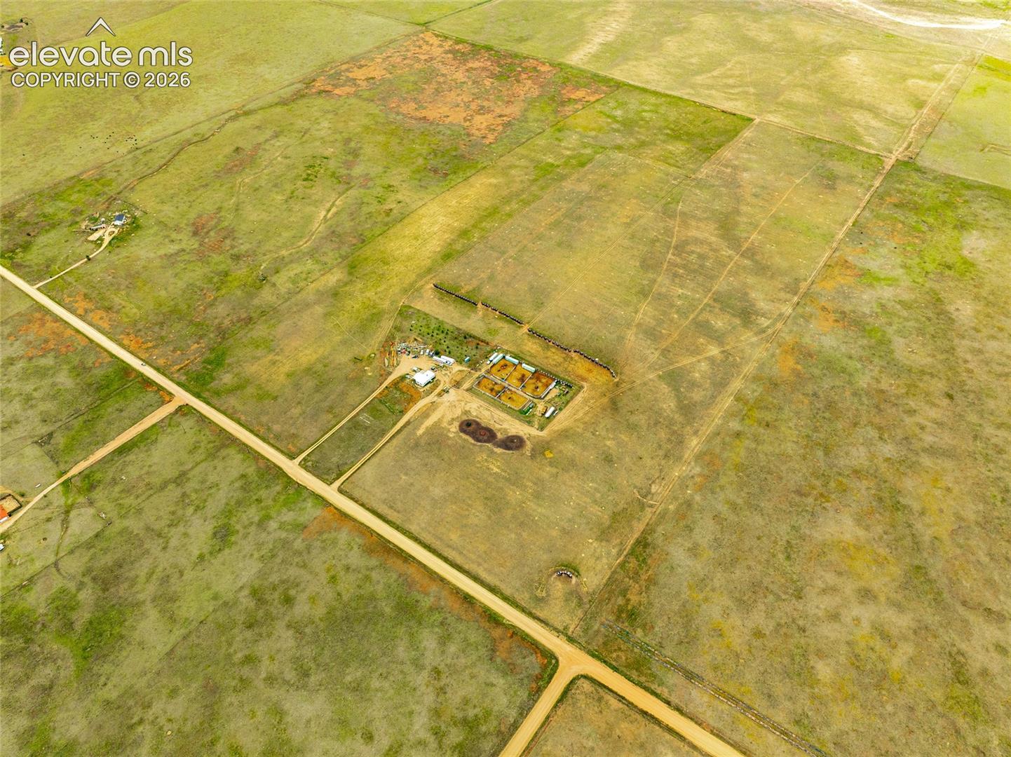 Expansive rural acreage featuring home, open pastureland, and direct dirt road access