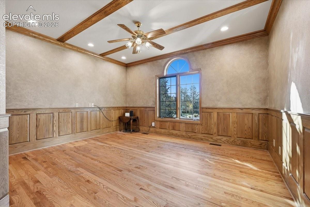 Currently used as an office, this bedroom offers French doors, beamed ceilings, and endless possibilities. 