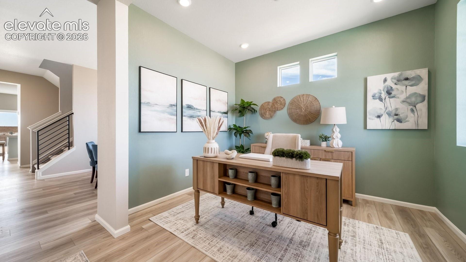 Office space featuring wood-finish flooring, recessed lighting, and high ceilings
*photos of a model home*