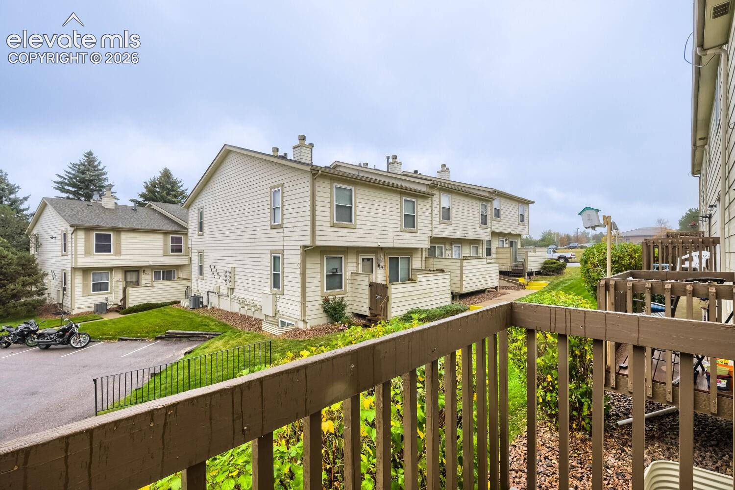 Multi-level residential exterior featuring horizontal siding and private wooden balconies