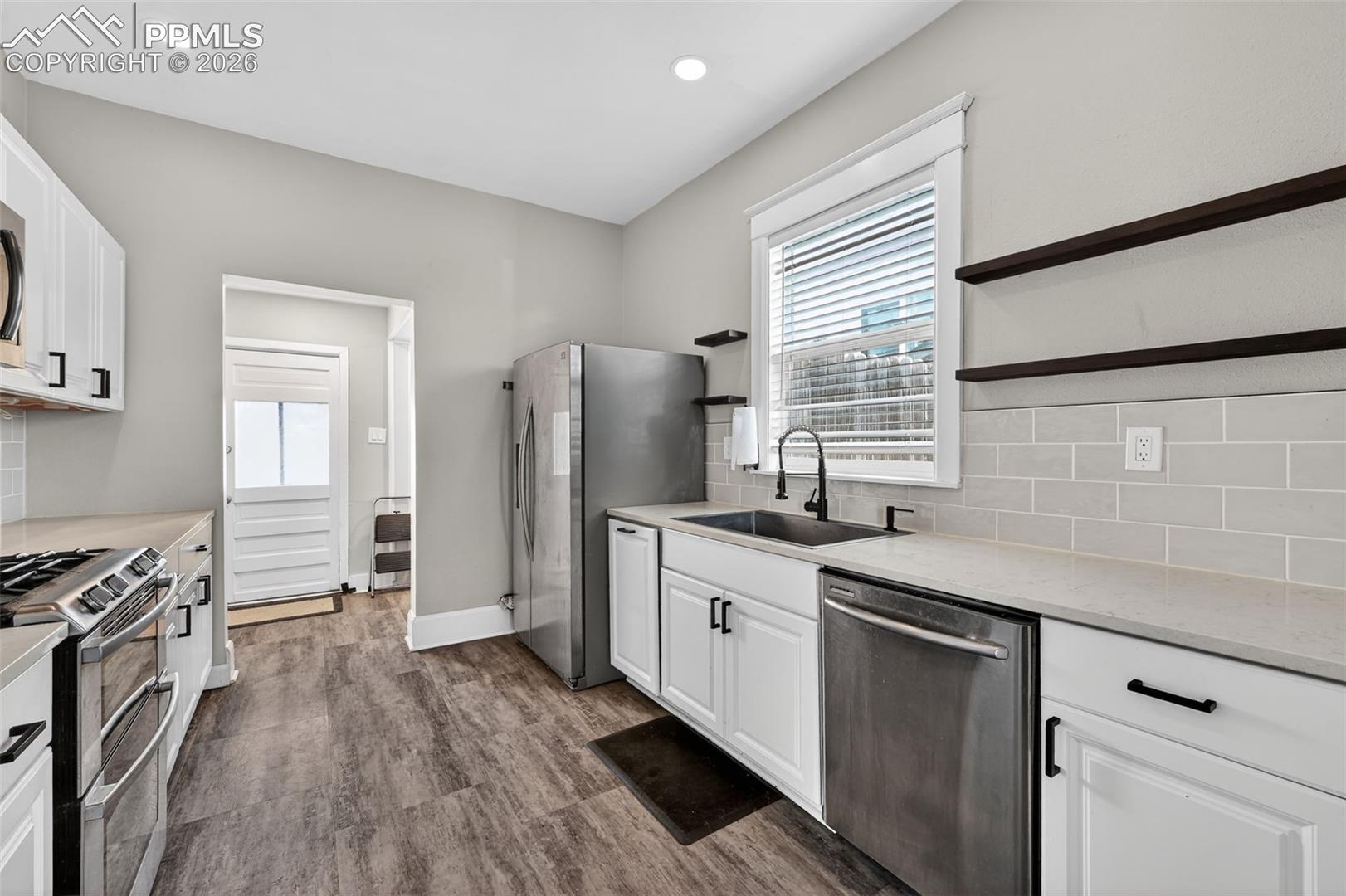 Large kitchen with quartz countertops and under-cabinet lighting
