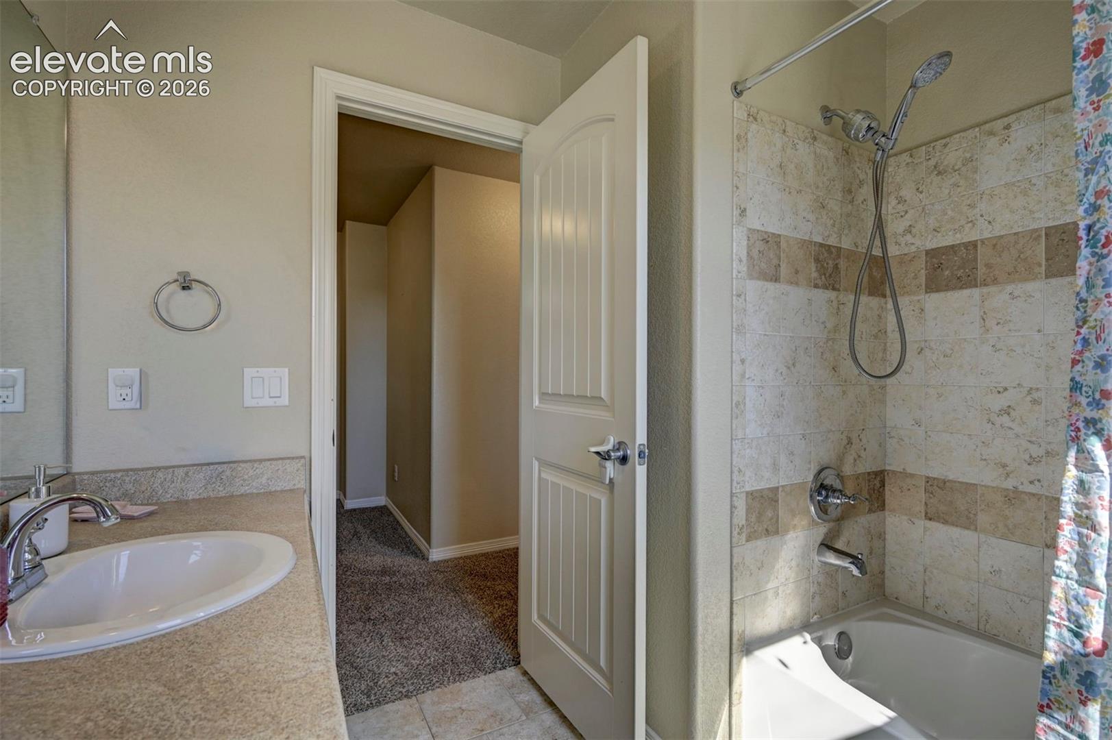 Built-in vanity with an oval sink, polished chrome faucet, and integrated countertop