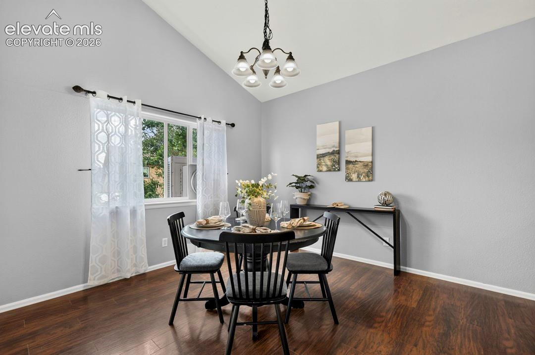 Vaulted ceiling with an integrated five-arm chandelier and dark wood-finish flooring