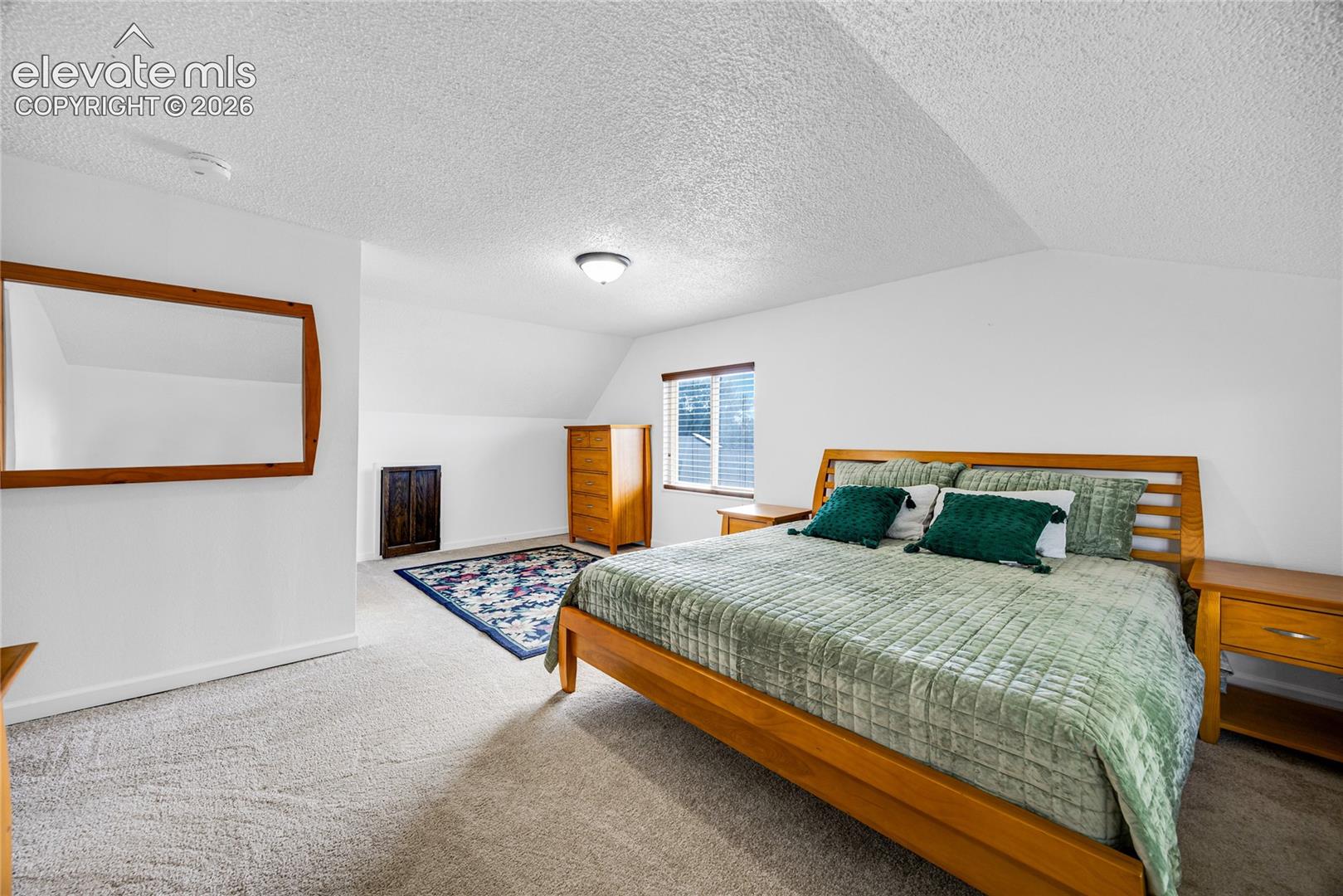 Primary bedroom with attached bathroom upper level
