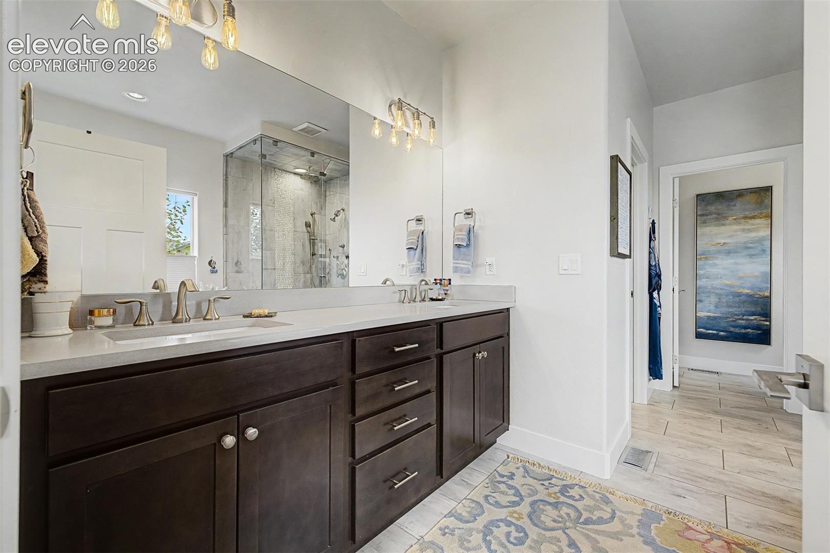 Quartz countertops, double sinks, lots of cabinets, beautiful lighting and more.