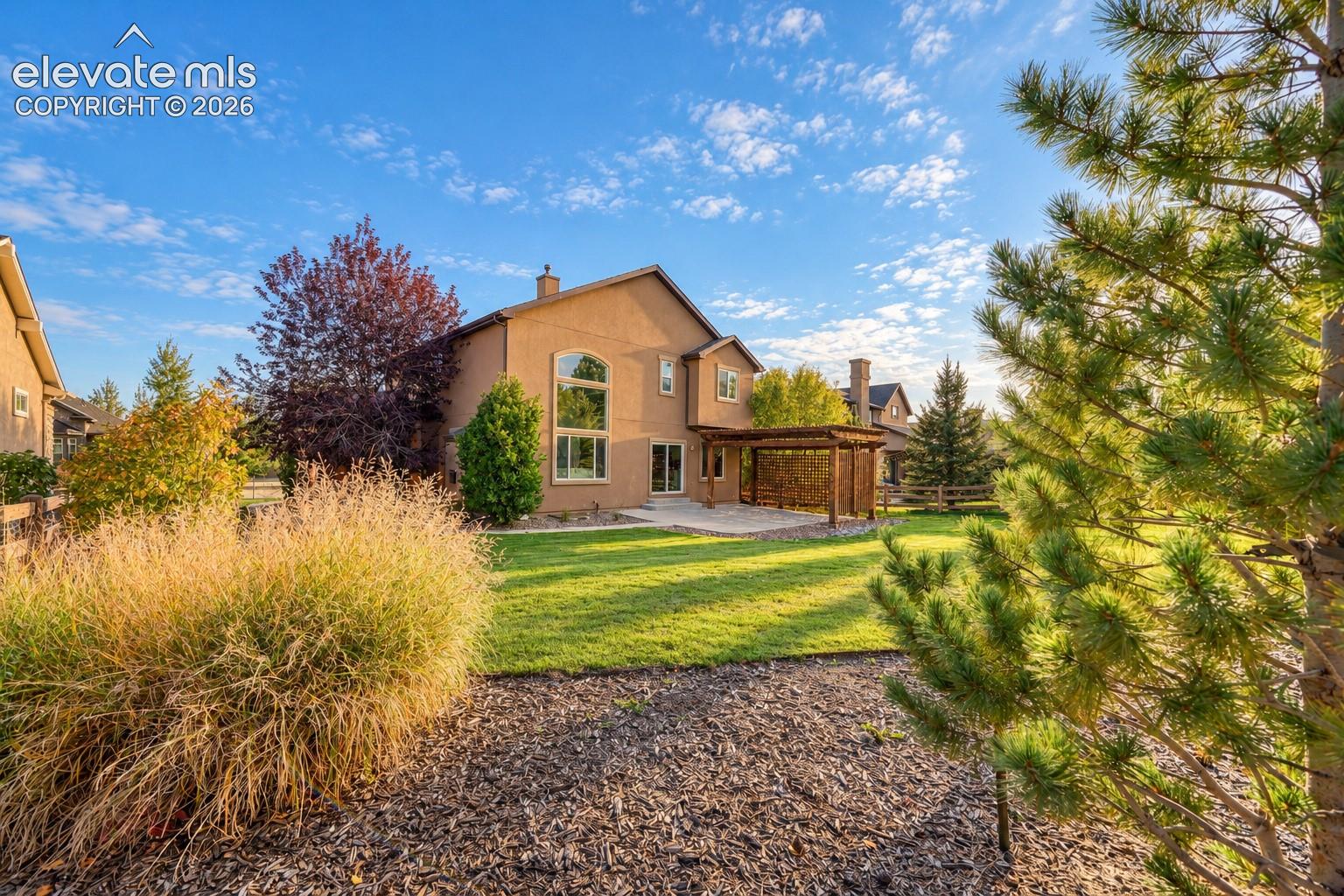 Elegant two-story residence with stucco exterior and arched window detailing
