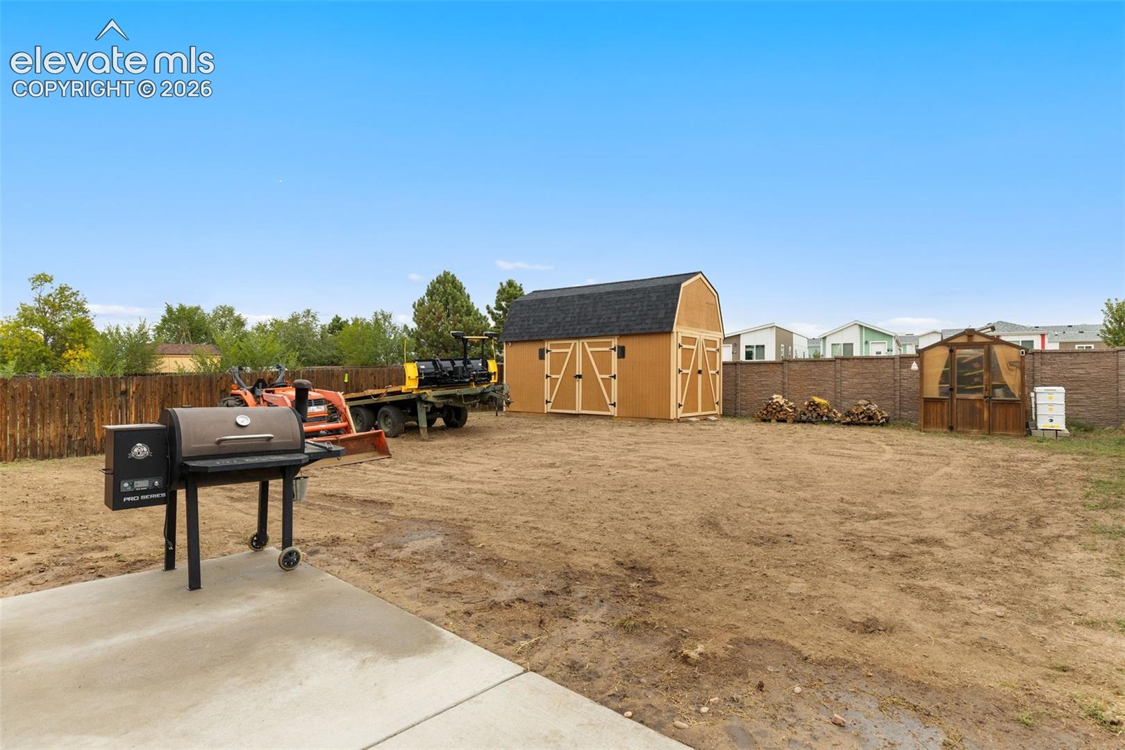 The expansive backyard features a massive storage shed and greenhouse, perfect for entertaining, relaxing, and storing all of your toys