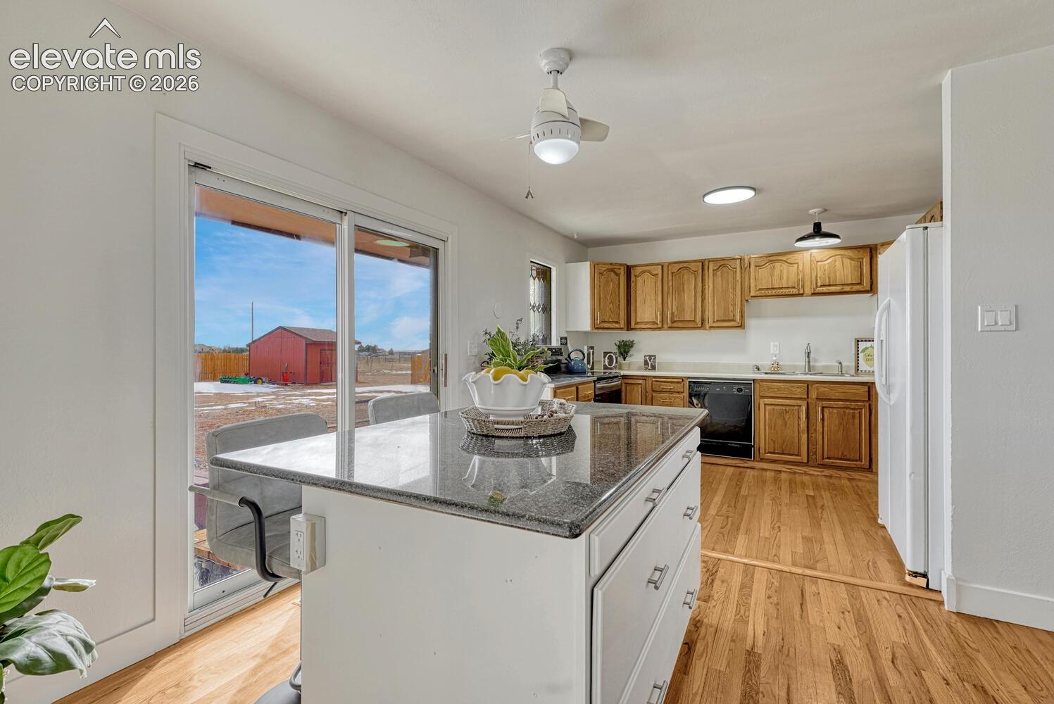 Kitchen on the south side of the house. Granite toped island and sliders to huge backyard