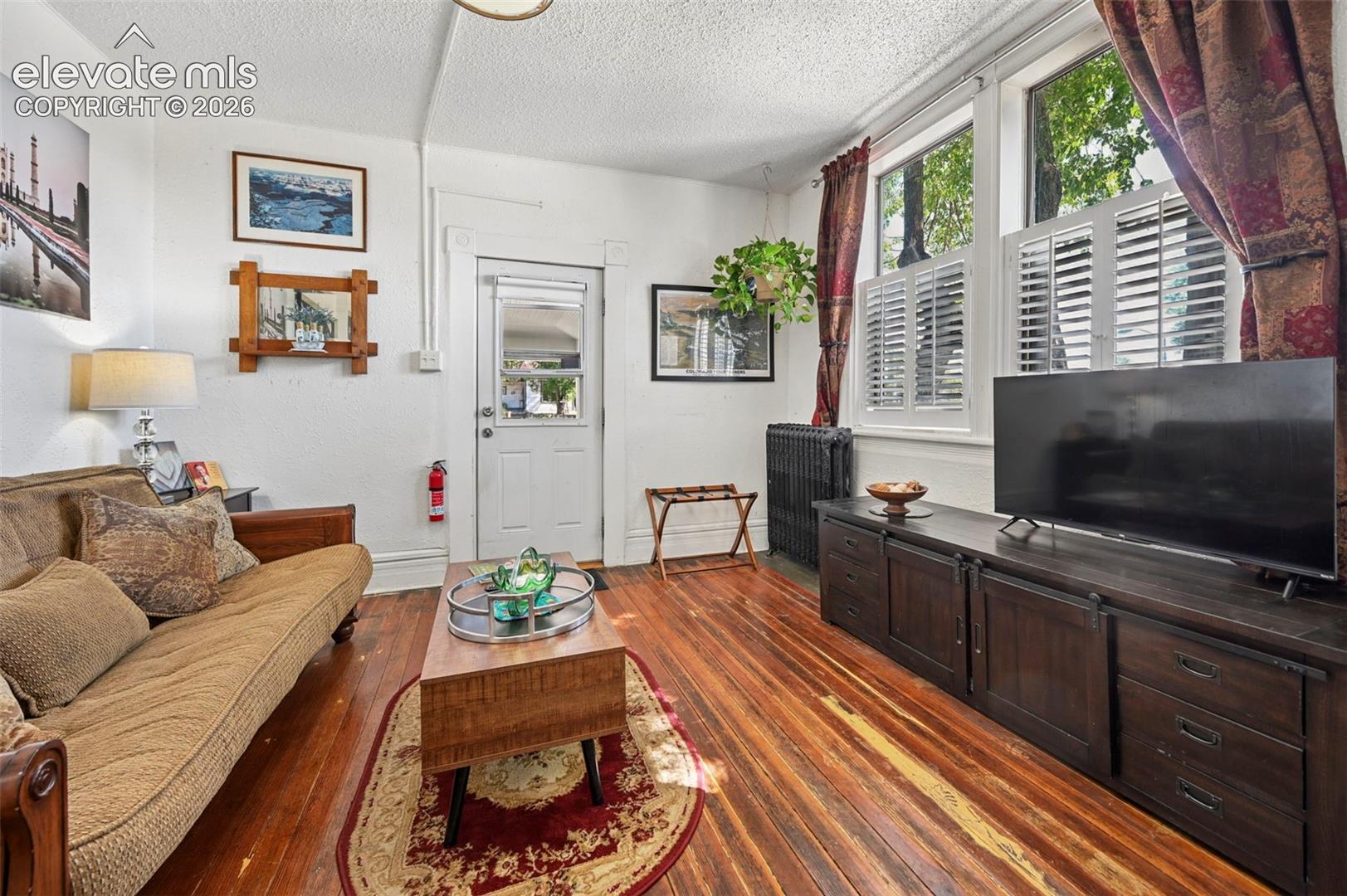 Apartment Living Room with original hardwood floors