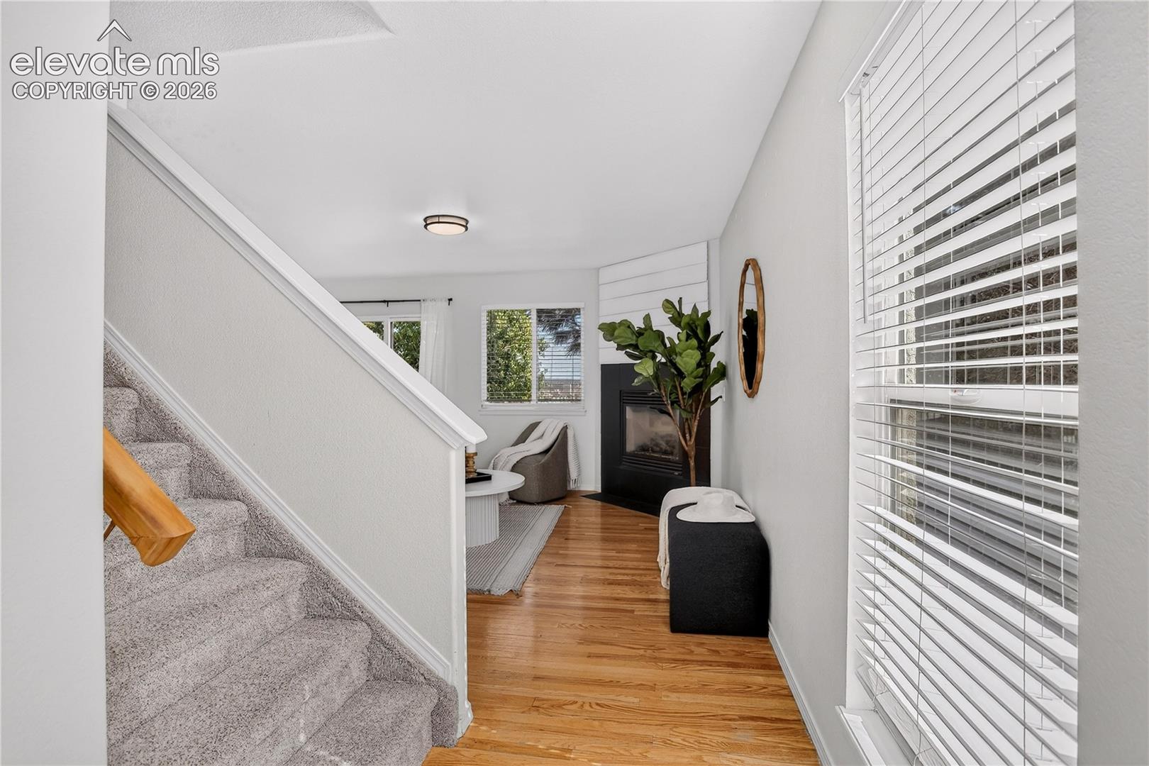 View from front door entry into living room with natural oak flooring.