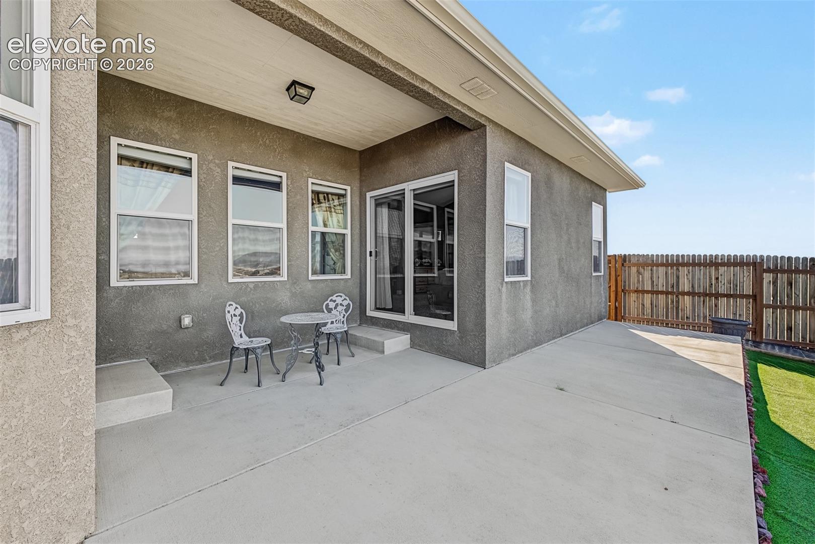 Covered patio accessed from the breakfast nook or the primary bedroom is the perfect place to watch the sun set over the mountains. 