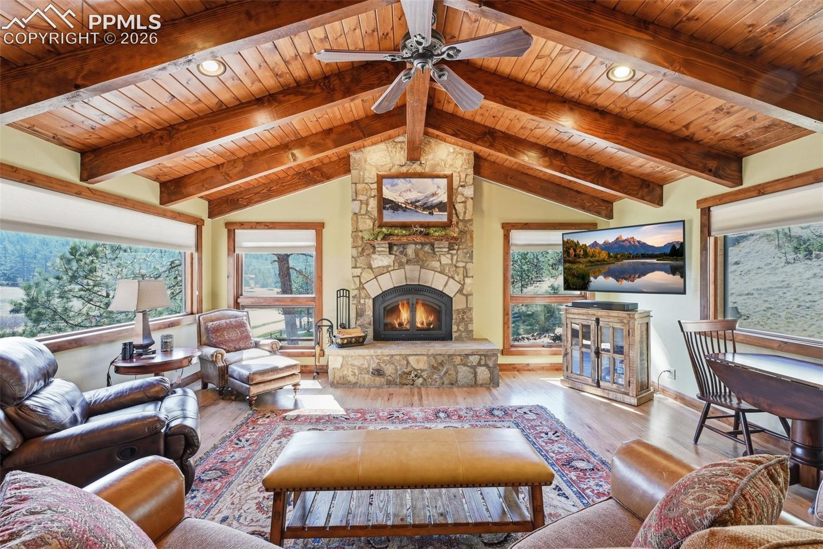 Soaring cathedral ceilings and surrounding picture windows perfectly frame this great living area. 