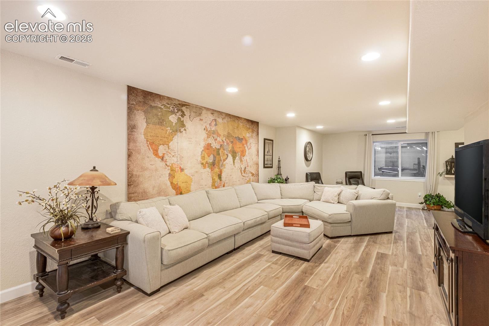 Neutral-toned interior featuring recessed lighting and wood-finish flooring