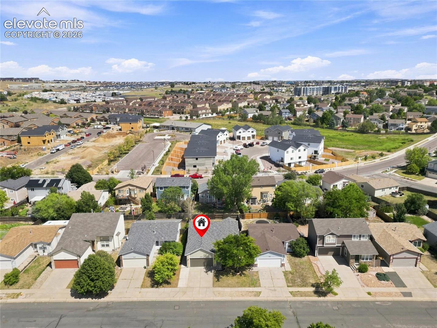 Single-family residence with an attached garage, paved driveway, and mature landscaping