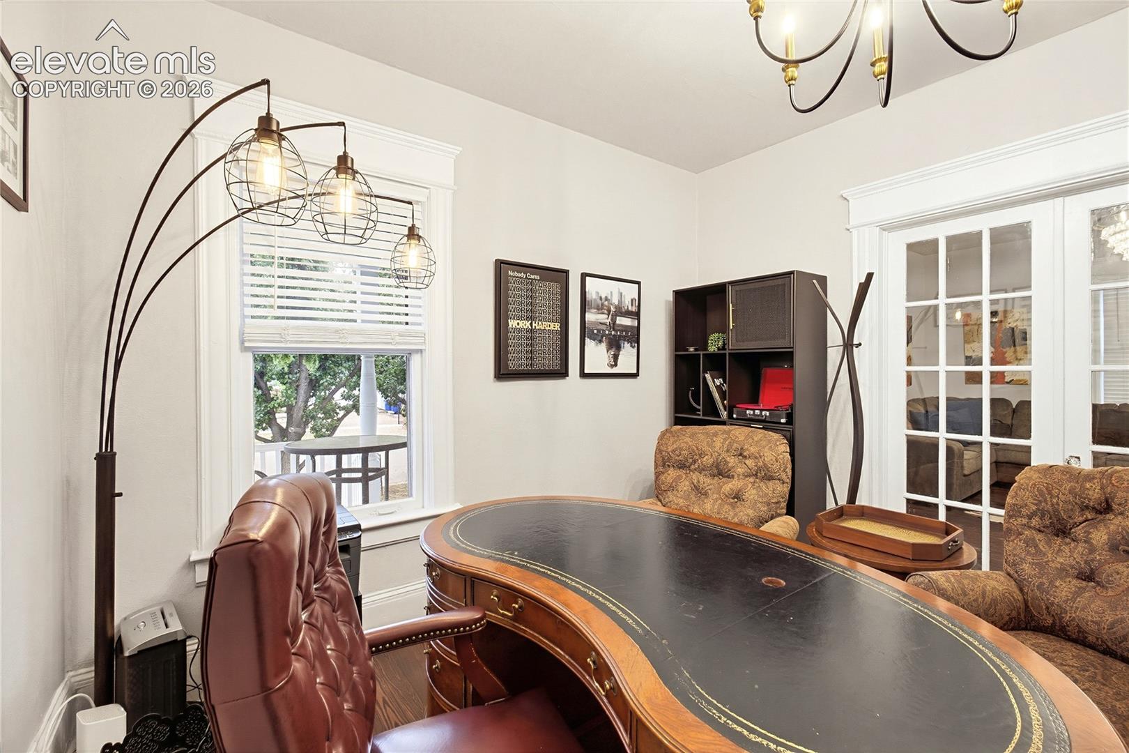 Interior room with a large window, white window blinds, and white trim