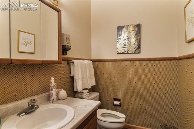 Half bathroom with toilet and vanity