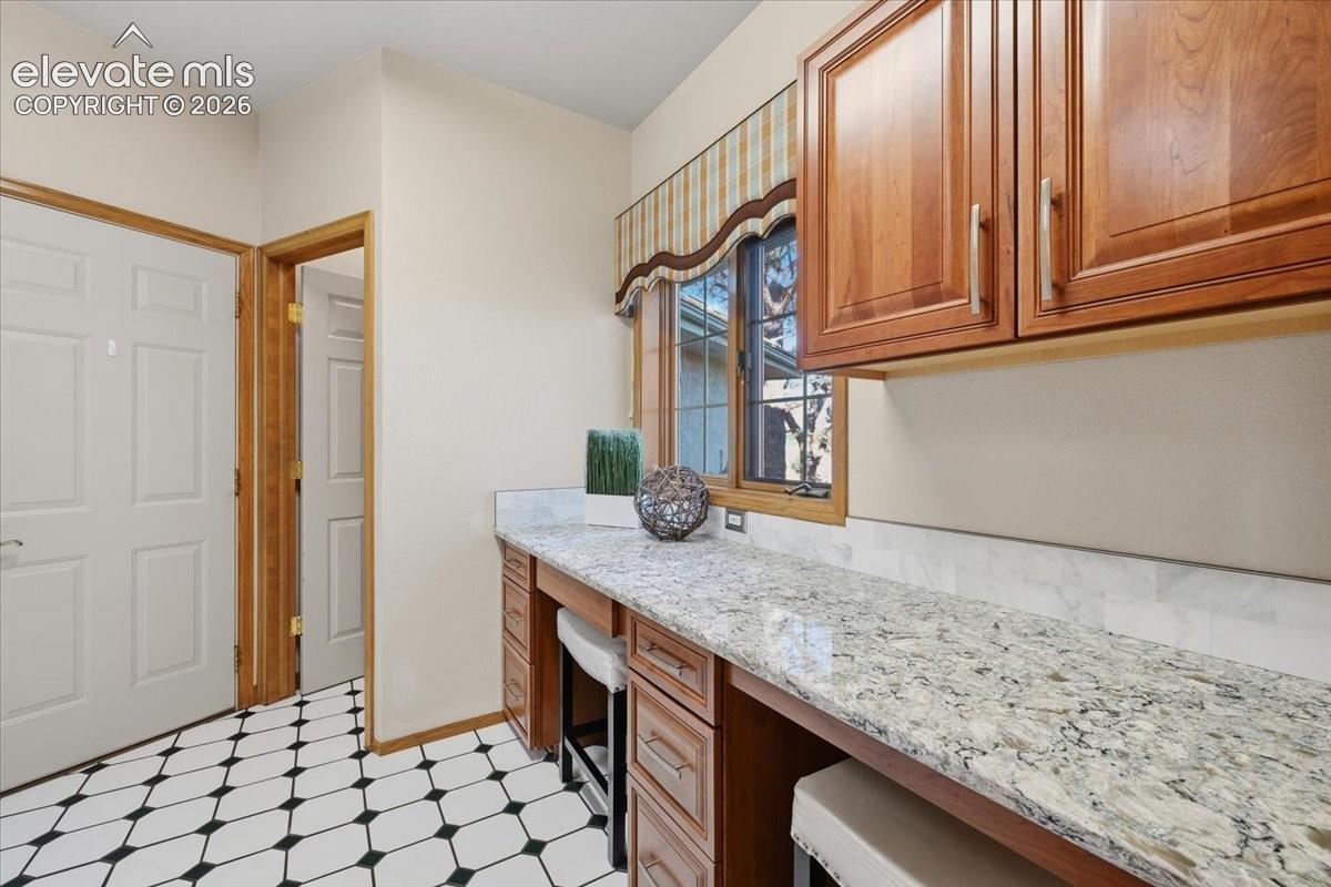 Built-in work/craft table and additional closet right off the garage. 