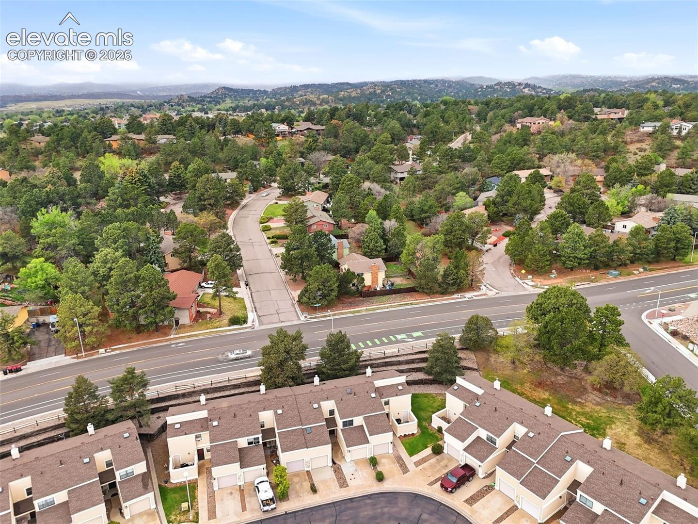 Aerial perspective showcasing a residential area with townhomes and detached properties