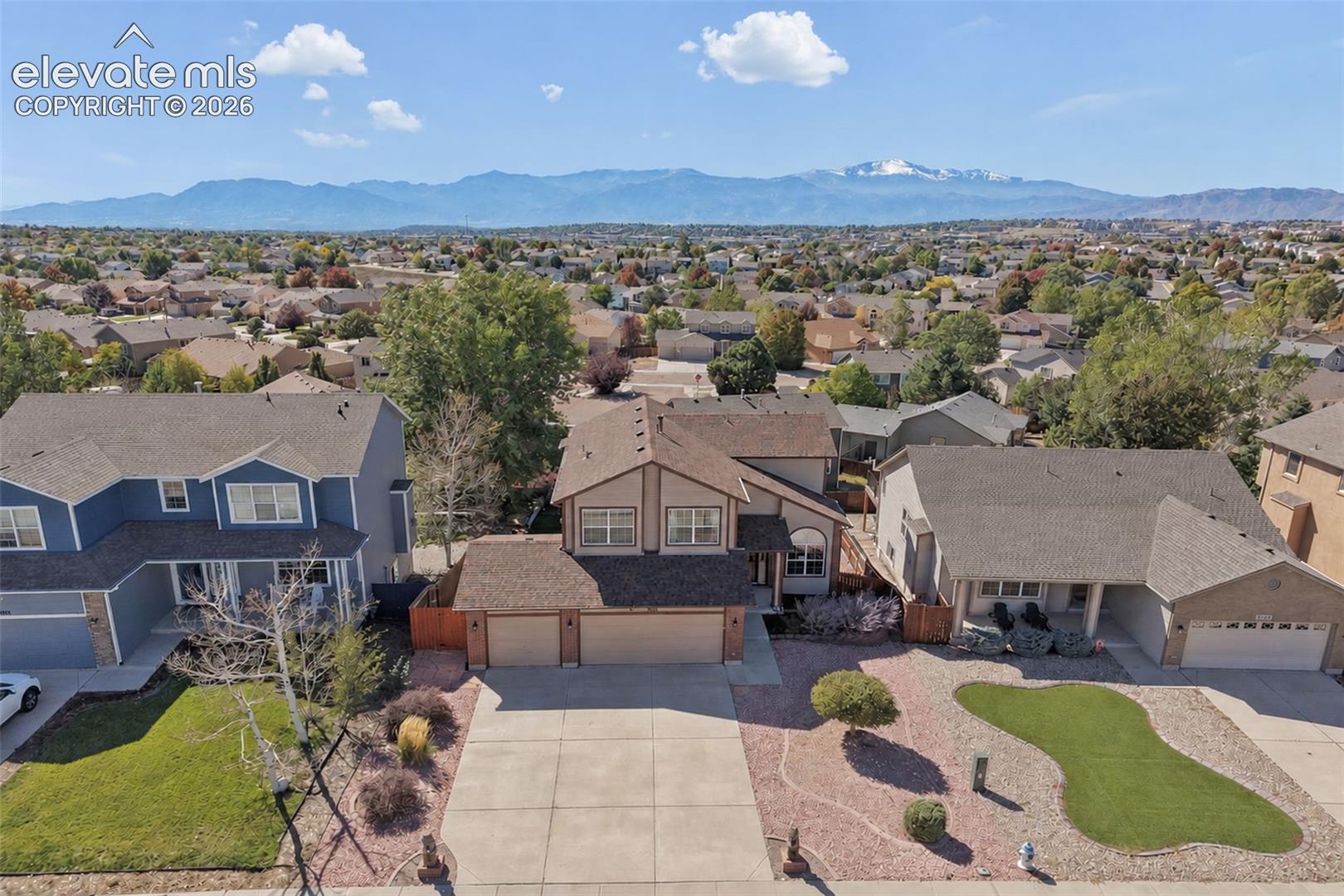 Residential property with a two-car garage, concrete driveway, and low-maintenance landscaping