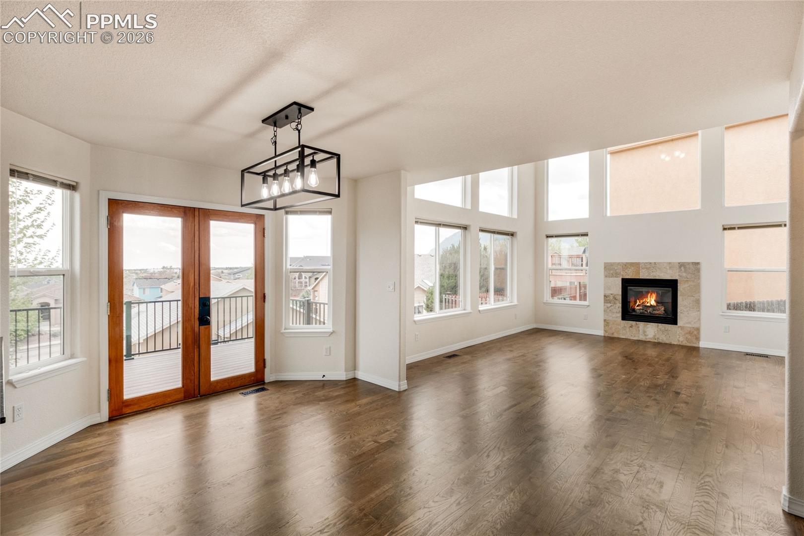 Spacious breakfast area with double glass-paneled doors opening to an exterior balcony. 