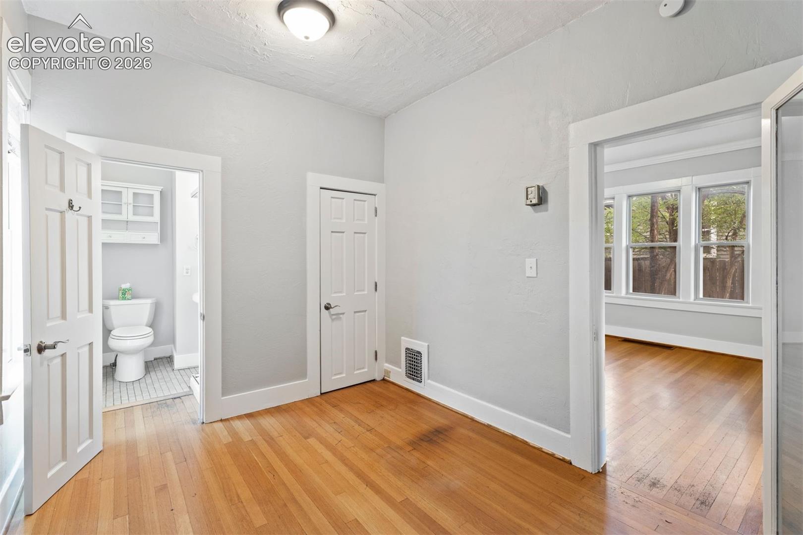 Main level bedroom with ensuite bathroom and walk in closet