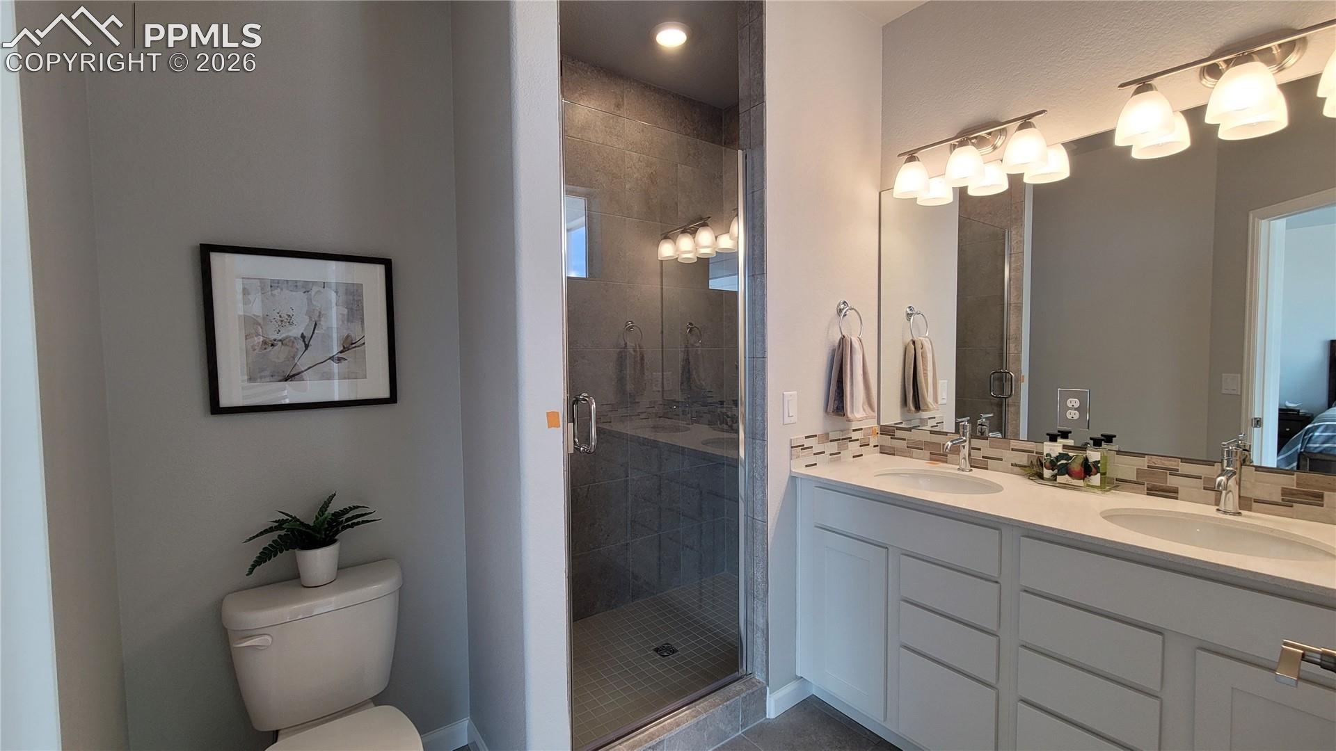 Primary Bathroom, double vanity, quartz countertop and tile surrounds! 
