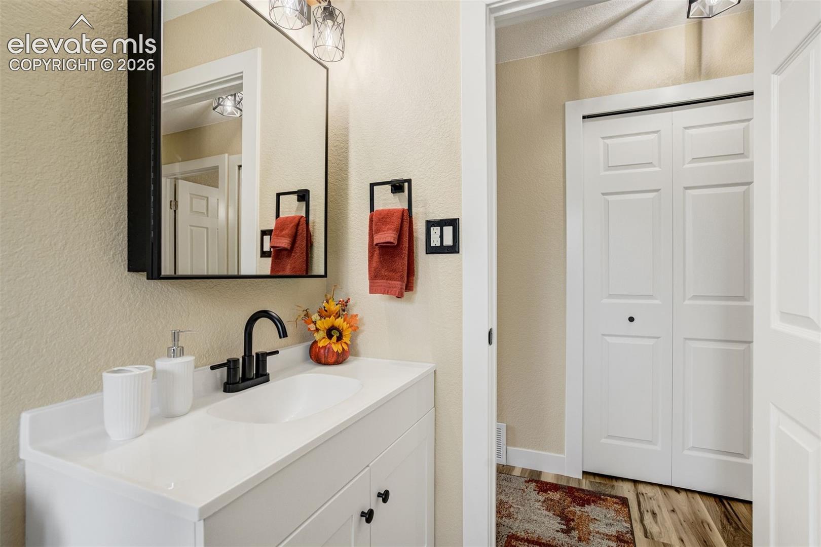 Large vanity with linen closet across the hall