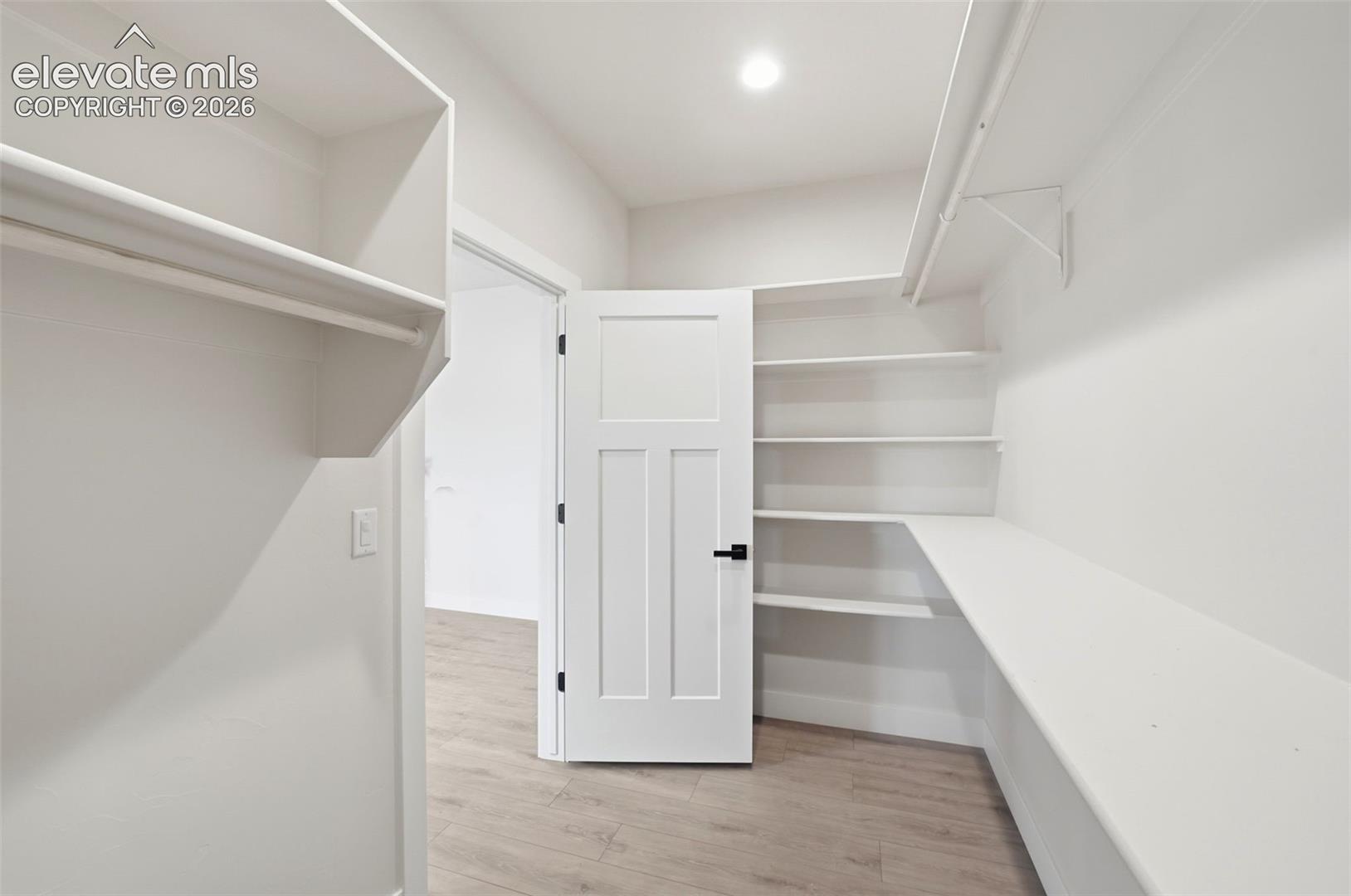 Primary Suite Walk in closet with built-in shelves