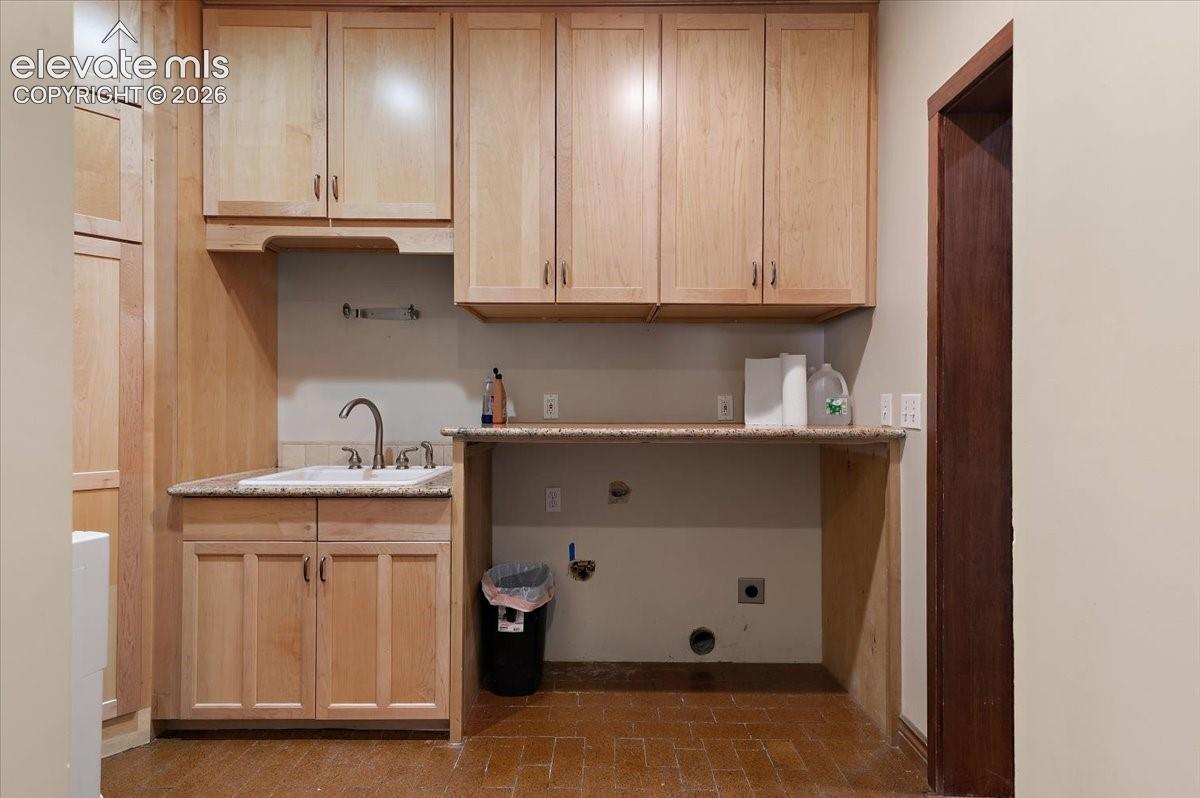 6 ft. X 10 ft. Laundry room with cabinets, folding table and deep utility sink