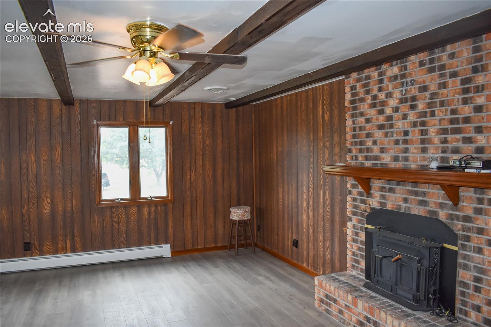 Brick fireplace with a wood-finish mantel and a built-in stove