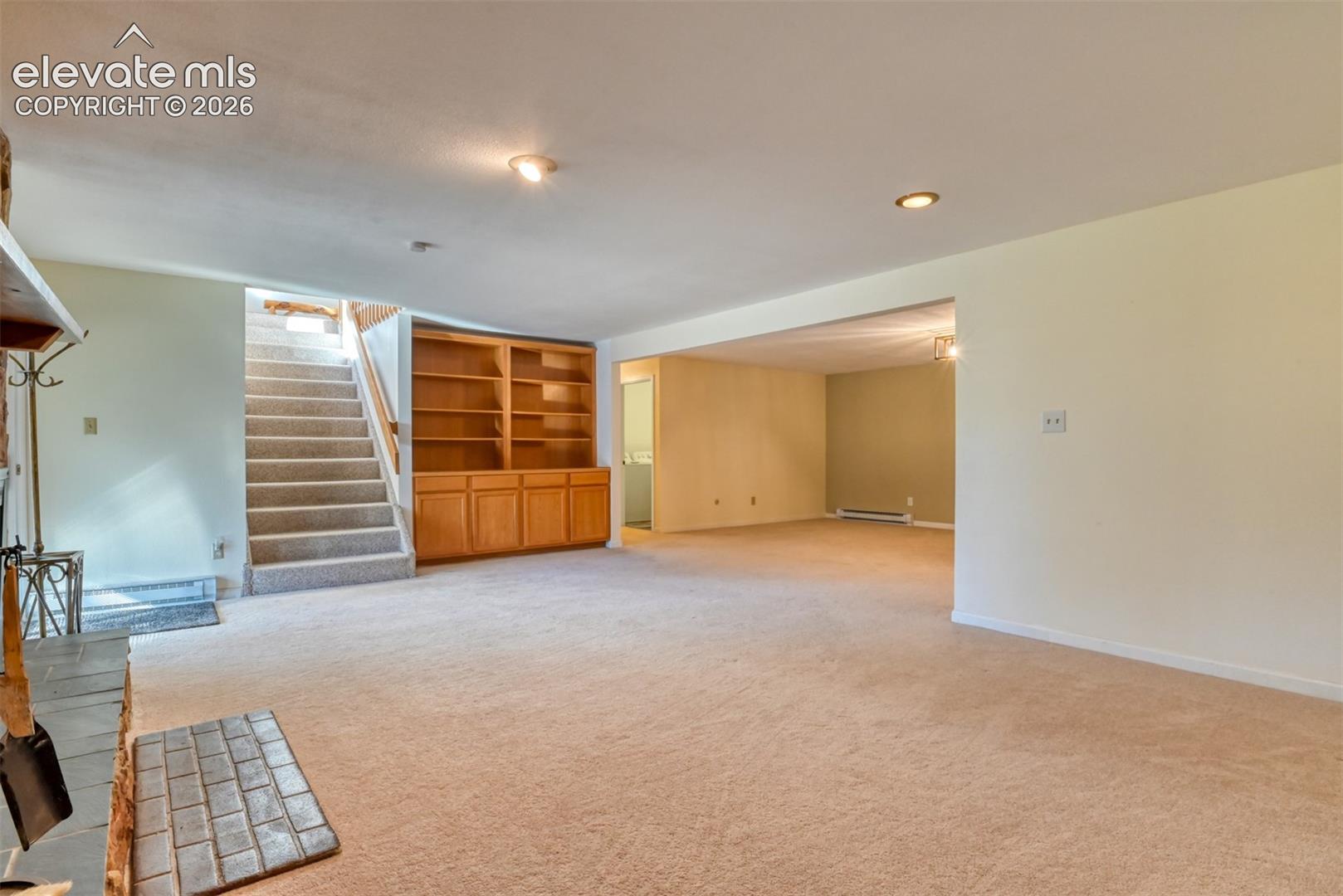 Family room has built-in book shelves. Door on right leads into the laundry room