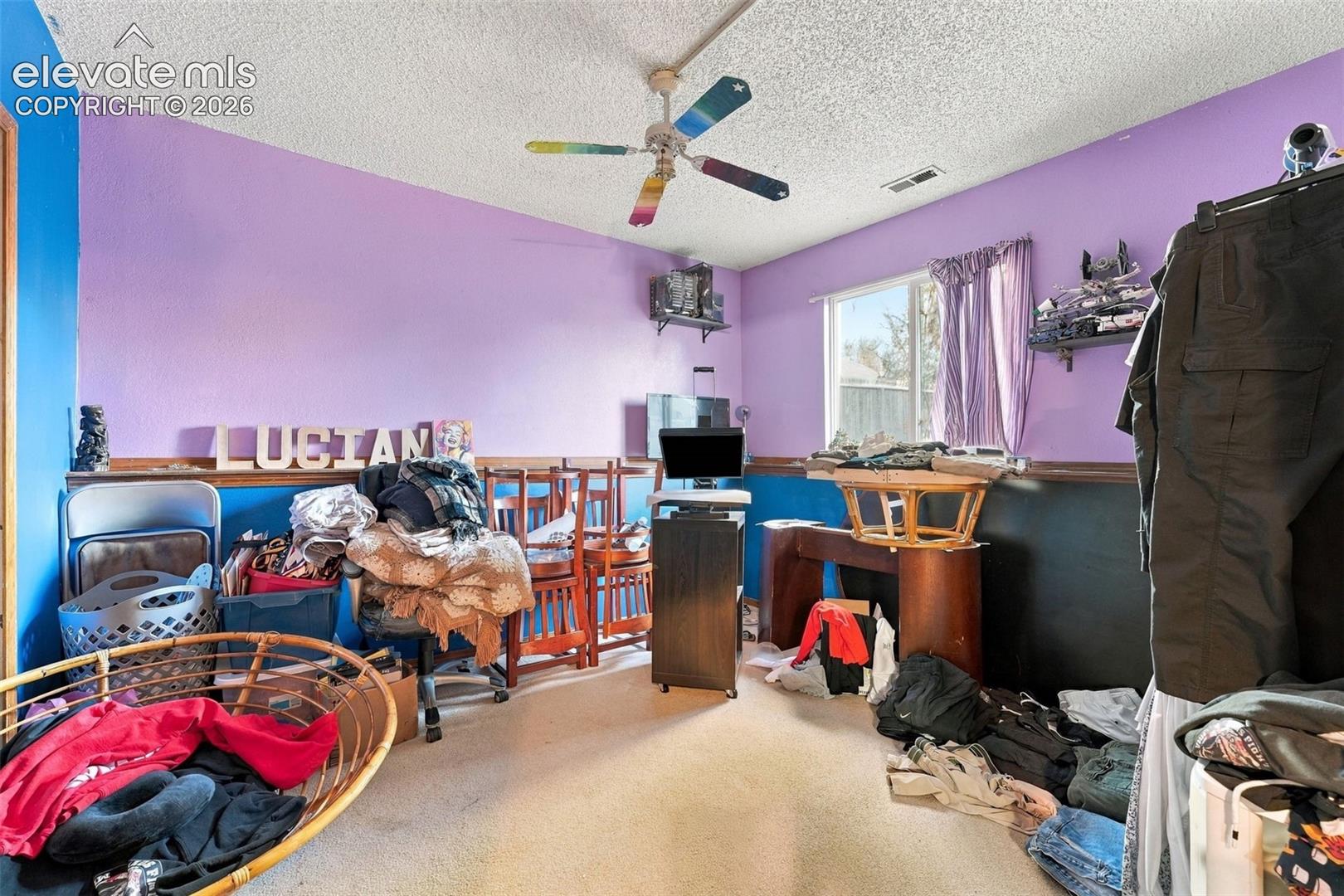 Room featuring wall-mounted shelving and a ceiling-mounted fan with integrated lighting