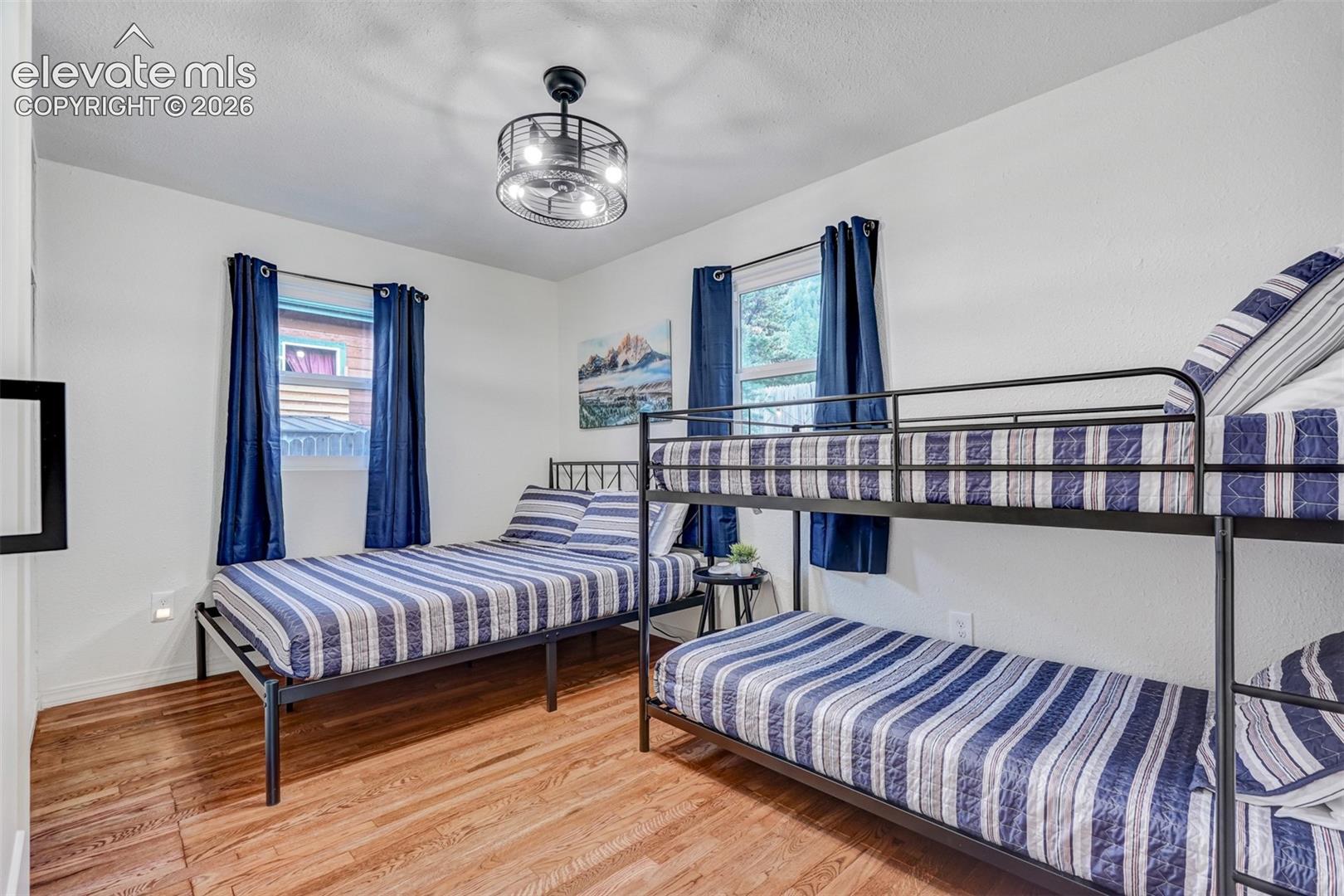 Wood-finish flooring with white walls and dual windows