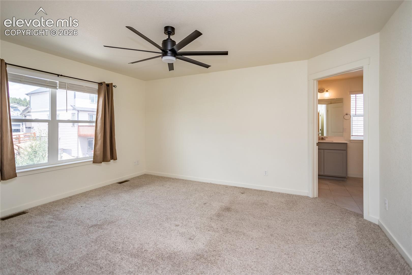 Generously sized primary suite with adjoining bathroom.